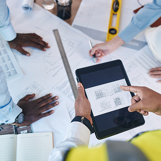 Facility team reviewing building floor plans for space optimization